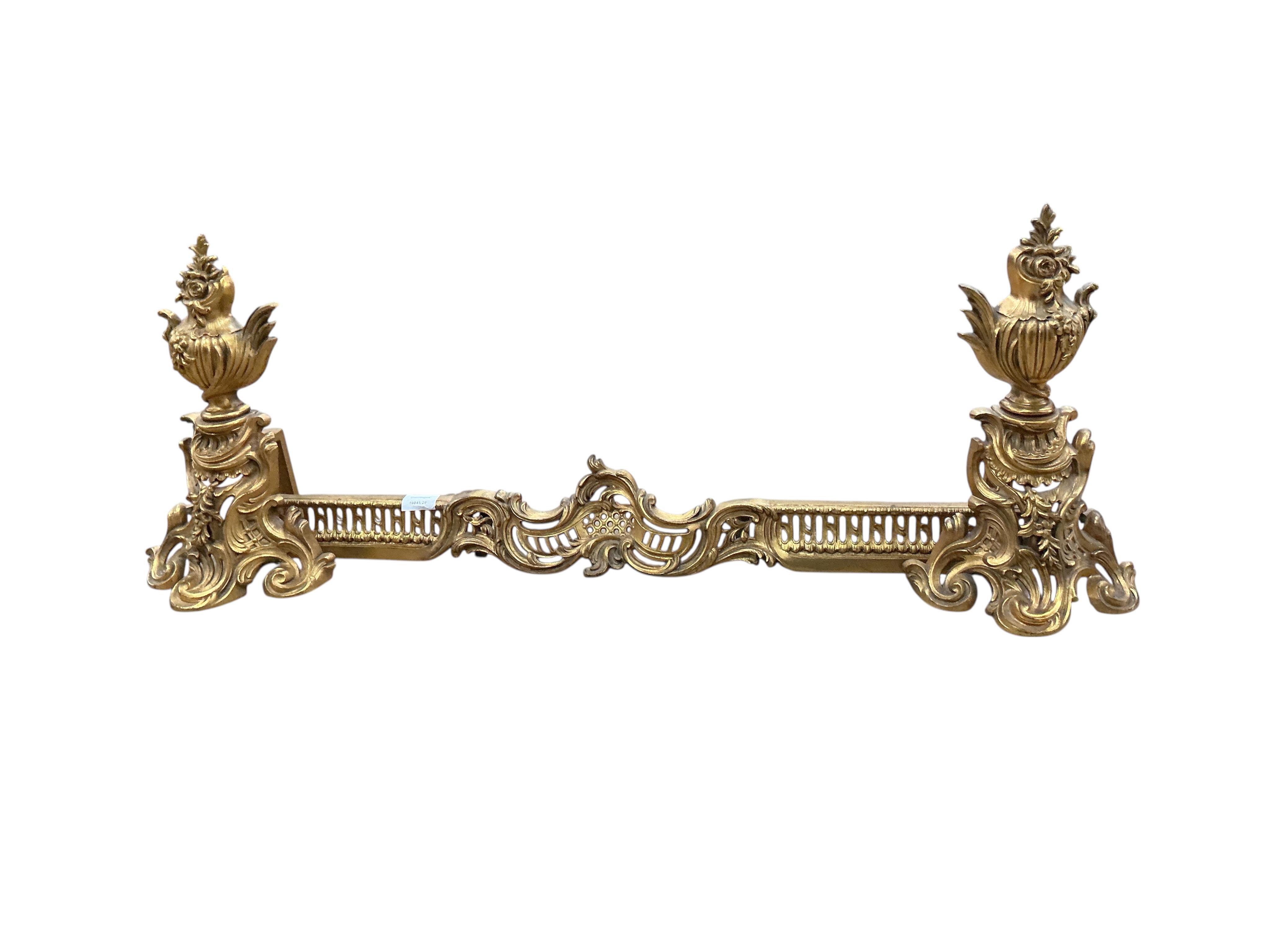 A late 19th century ormolu fender with chenets